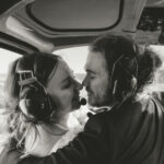 Adventure elopement couple kissing on a helicopter tour.